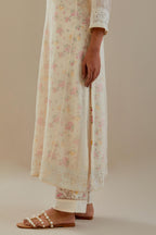 Off white cotton chanderi straight kurta set with embroidered button placket neckline and delicate bead, thread tassel work at side panel joint seams.