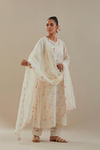 Off white cotton chanderi straight kurta set with embroidered button placket neckline and delicate bead, thread tassel work at side panel joint seams.