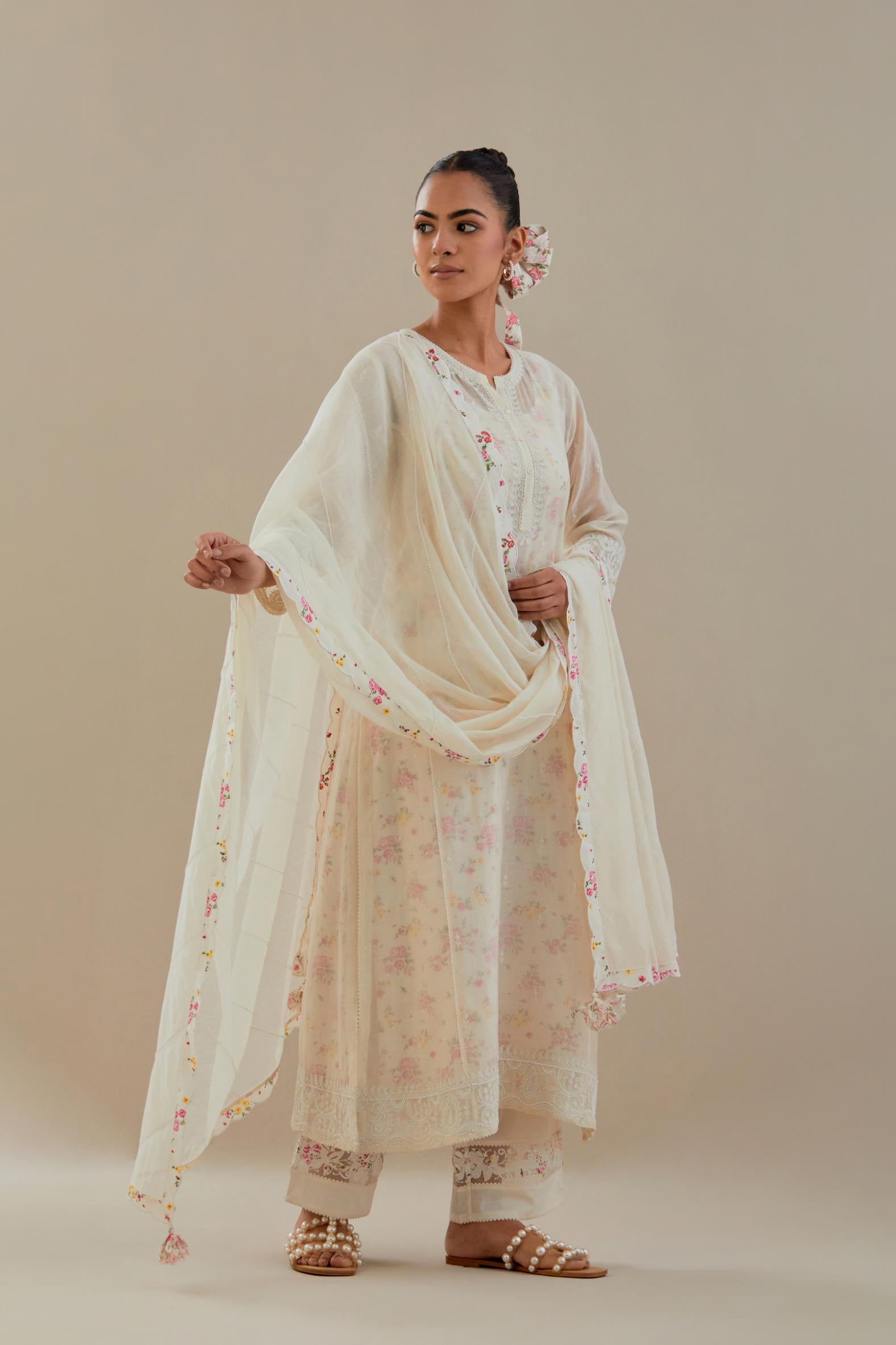 Off white cotton chanderi straight kurta set with embroidered button placket neckline and delicate bead, thread tassel work at side panel joint seams.