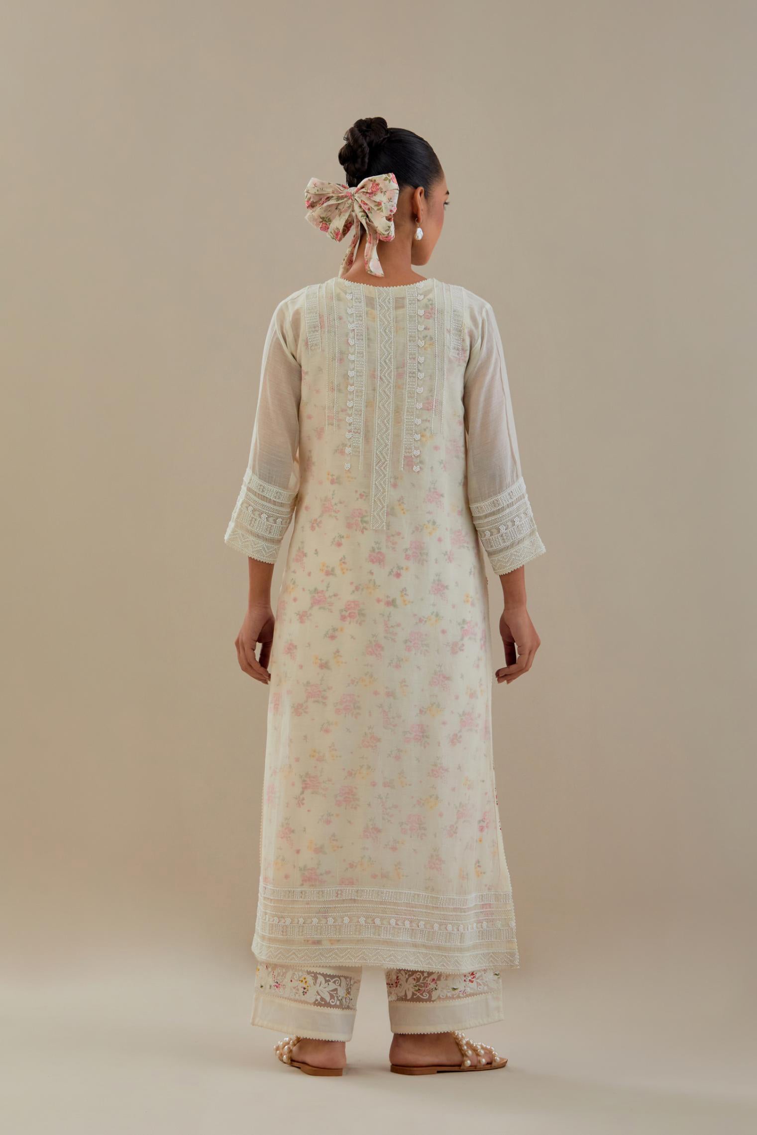Off white cotton chanderi straight kurta set with off white thread embroidery and delicate beaded hand work at neck, sleeve and hem.