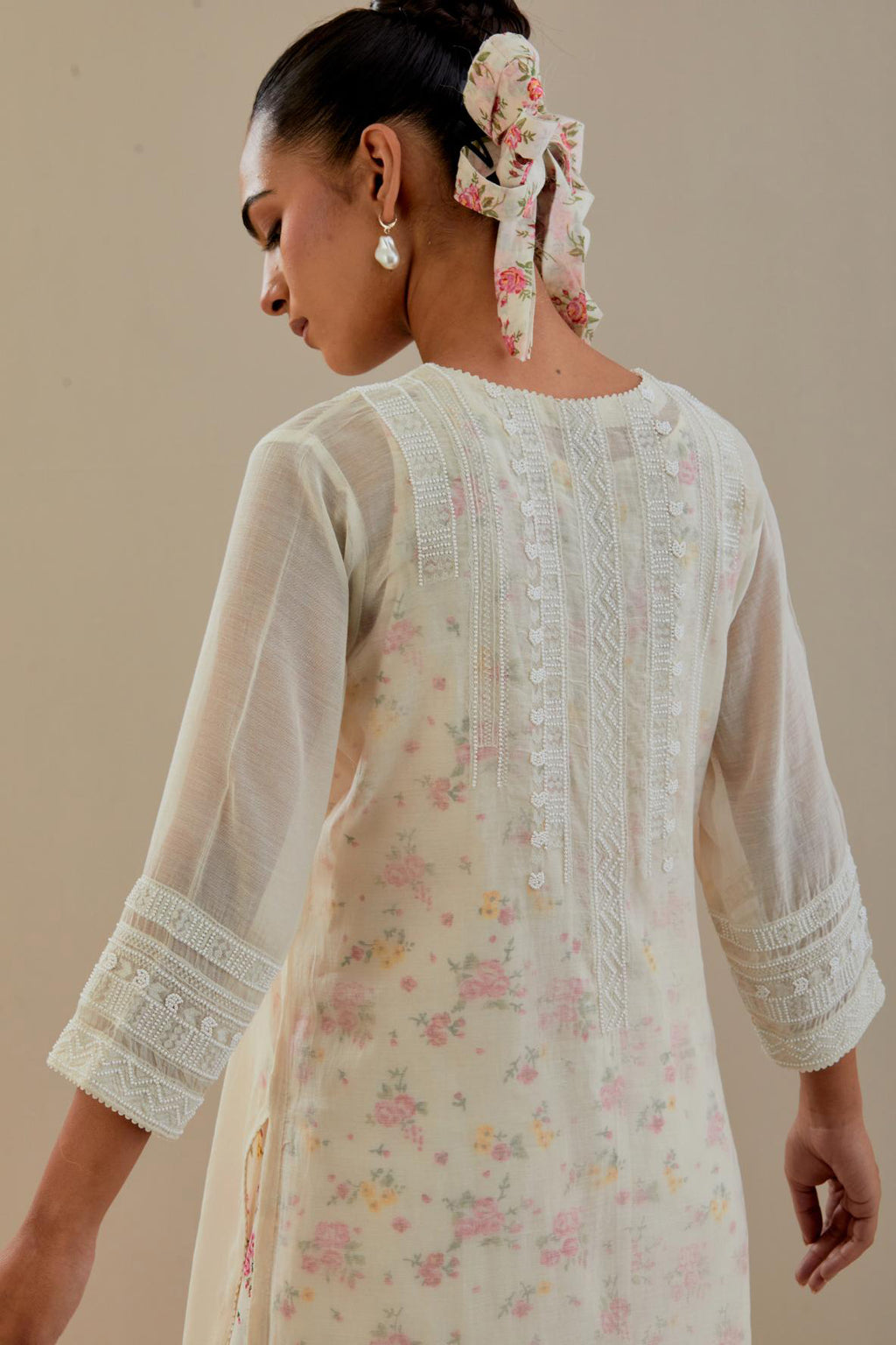 Off white cotton chanderi straight kurta set with off white thread embroidery and delicate beaded hand work at neck, sleeve and hem.