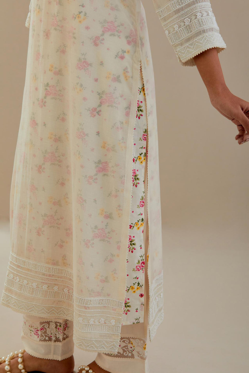 Off white cotton chanderi straight kurta set with off white thread embroidery and delicate beaded hand work at neck, sleeve and hem.