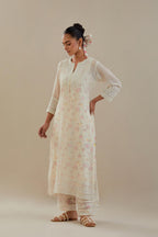 Off white cotton chanderi straight kurta set with off white thread embroidery and delicate beaded hand work at neck, sleeve and hem.