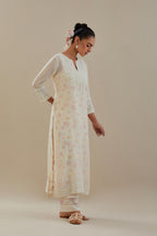 Off white cotton chanderi straight kurta set with off white thread embroidery and delicate beaded hand work at neck, sleeve and hem.