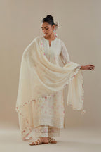 Off white cotton chanderi straight kurta set with off white thread embroidery and delicate beaded hand work at neck, sleeve and hem.