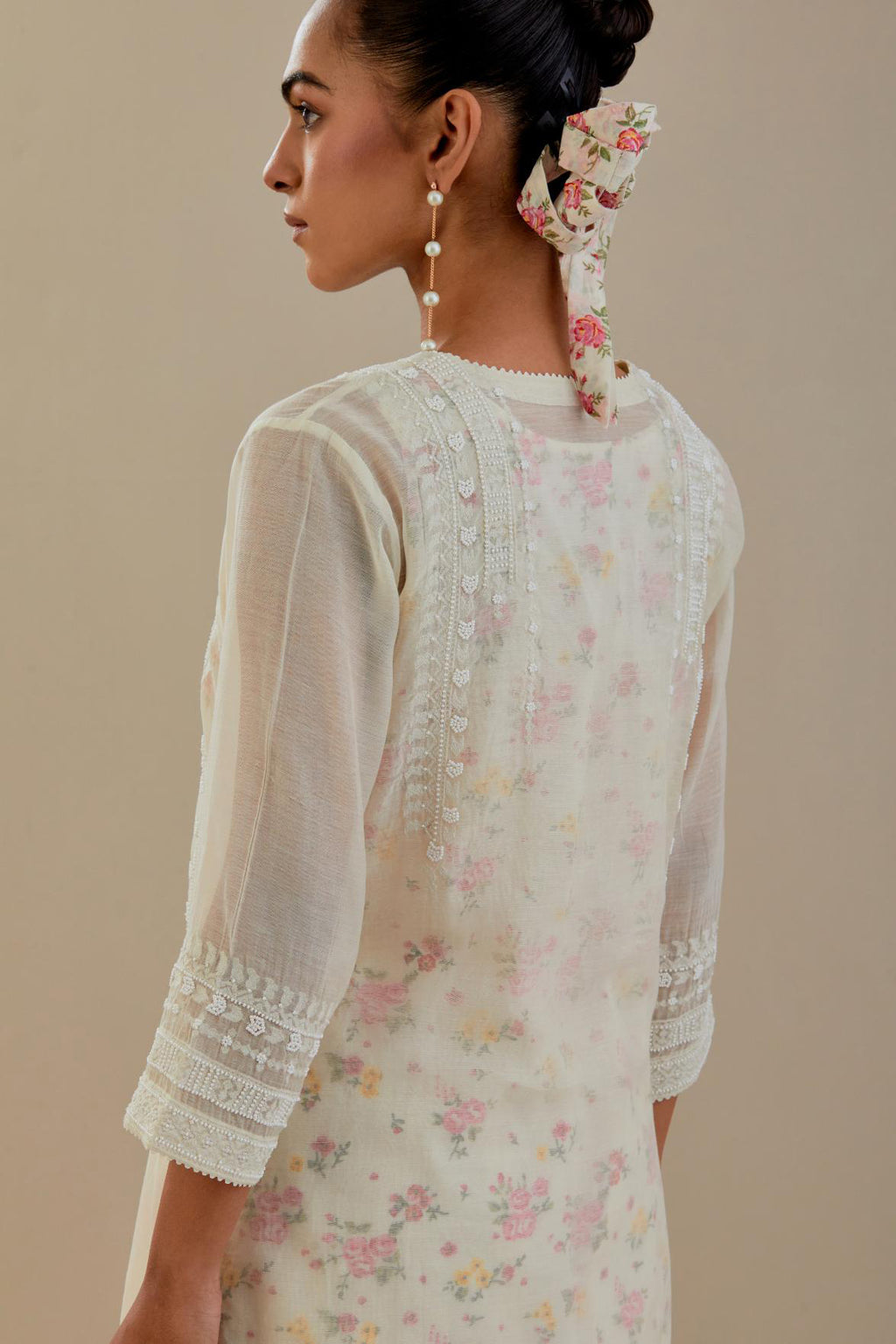 Off white cotton chanderi short kurta set, highlighted with delicate beads and thread embroidery.