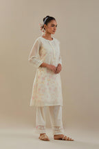 Off white cotton chanderi short kurta set, highlighted with delicate beads and thread embroidery.