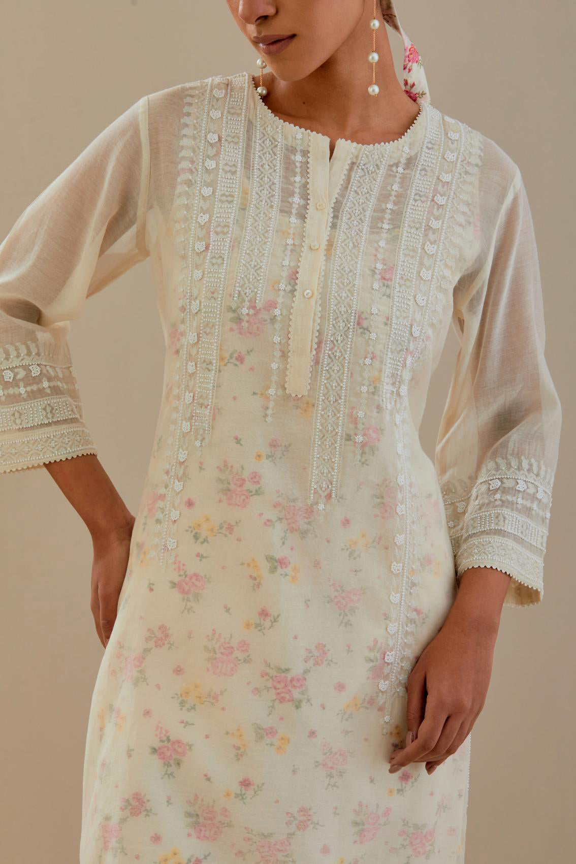 Off white cotton chanderi short kurta set, highlighted with delicate beads and thread embroidery.