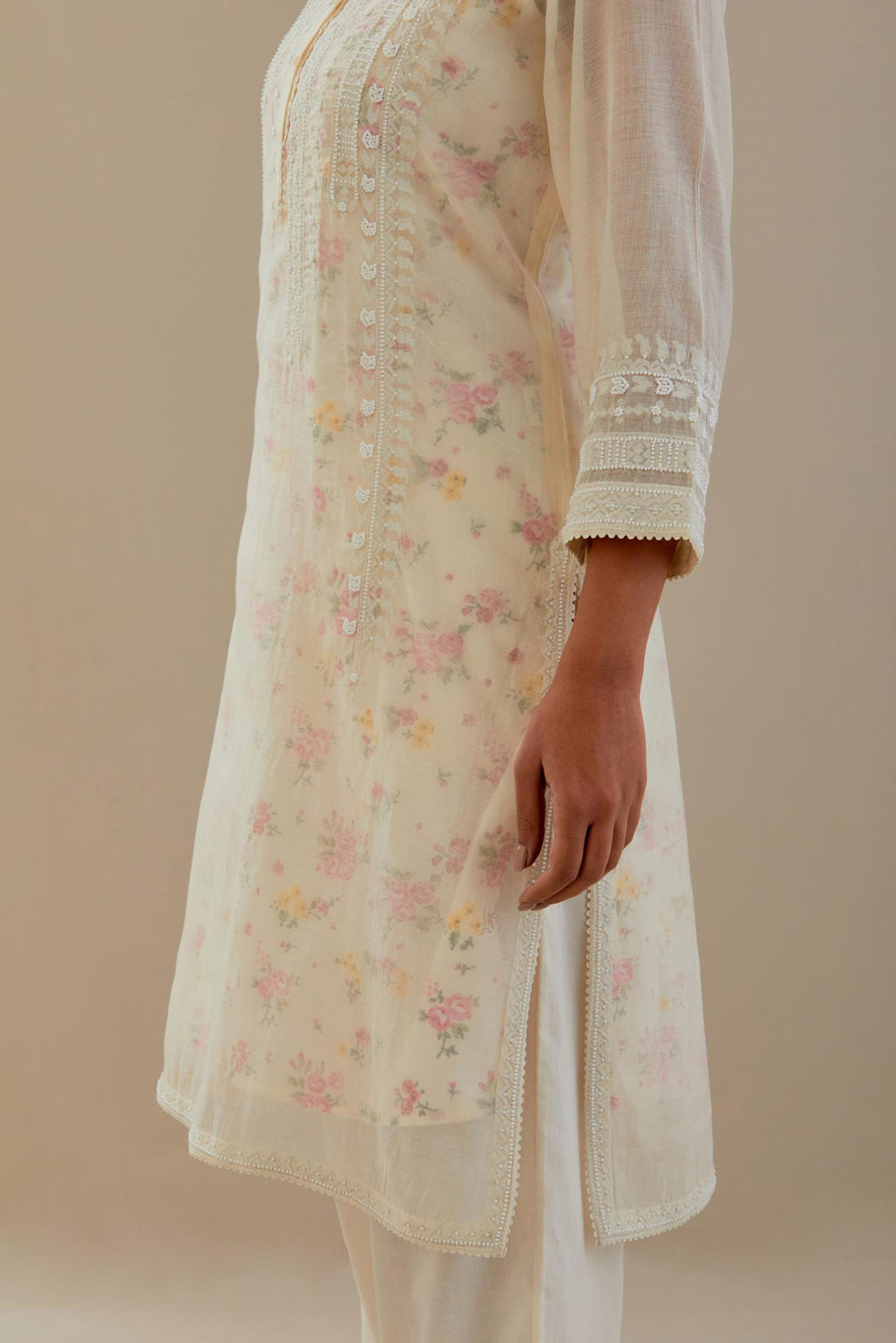 Off white cotton chanderi short kurta set, highlighted with delicate beads and thread embroidery.