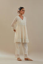 Off white cotton Chanderi short Angrakha kurta set with all-over off white beads and thread embroidery.