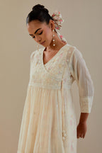 Off white cotton Chanderi short Angrakha kurta set with all-over off white beads and thread embroidery.