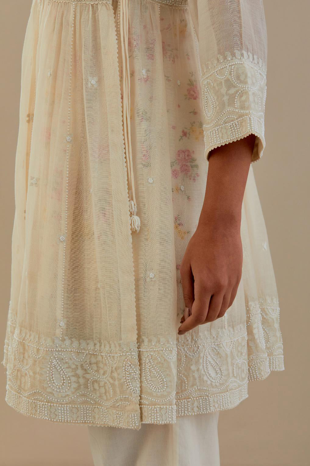 Off white cotton Chanderi short Angrakha kurta set with all-over off white beads and thread embroidery.