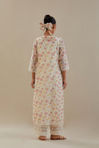 Off white cotton chanderi kurta set with small floral hand block print, highlighted with applique embroidery and ricrac lace.