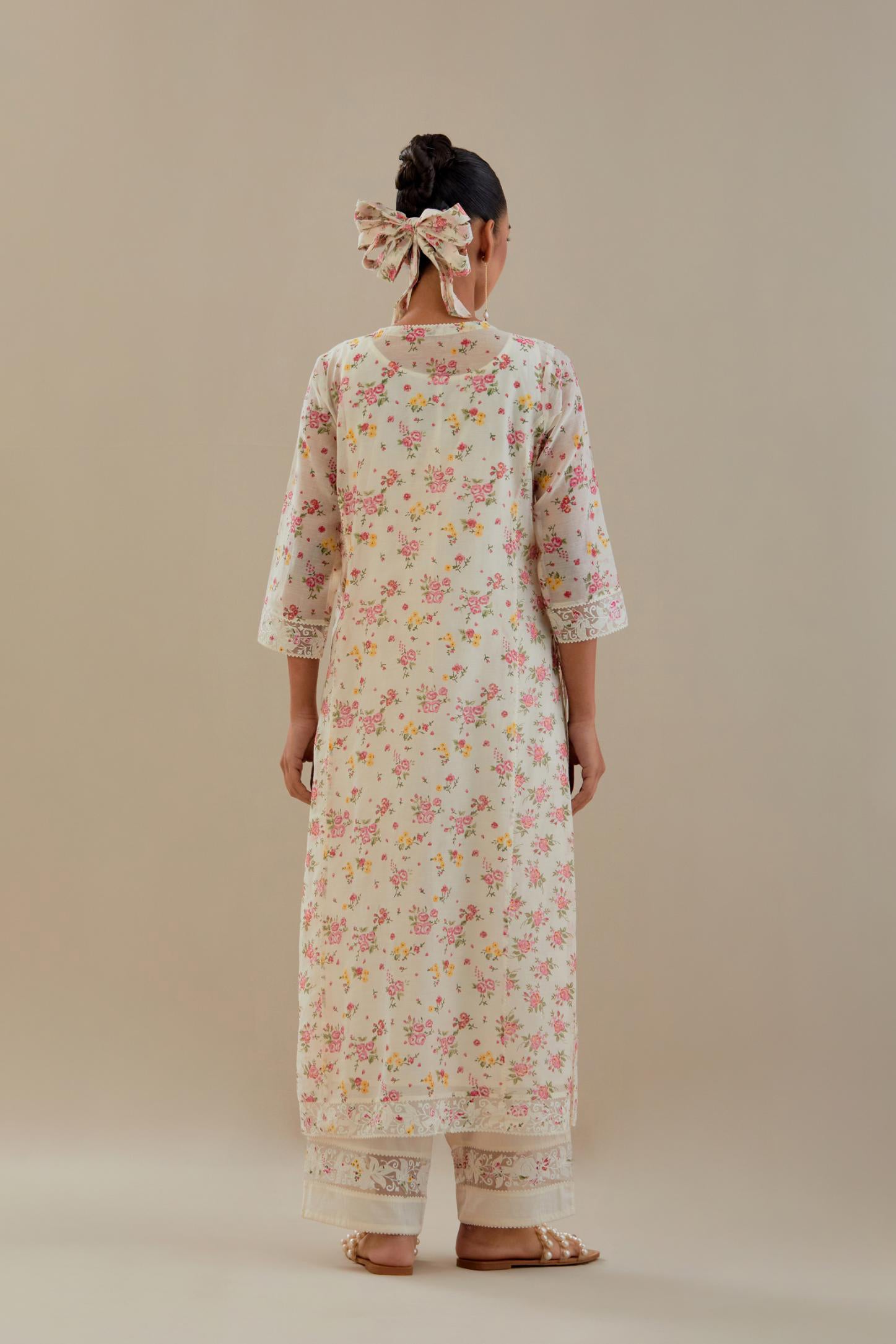 Off white cotton chanderi kurta set with small floral hand block print, highlighted with applique embroidery and ricrac lace.