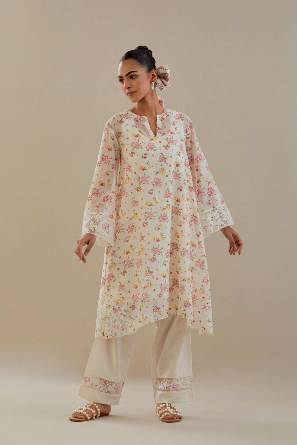 Off white cotton chanderi A-line short kurta set with small floral hand block print, highlighted with applique embroidery and ricrac lace.