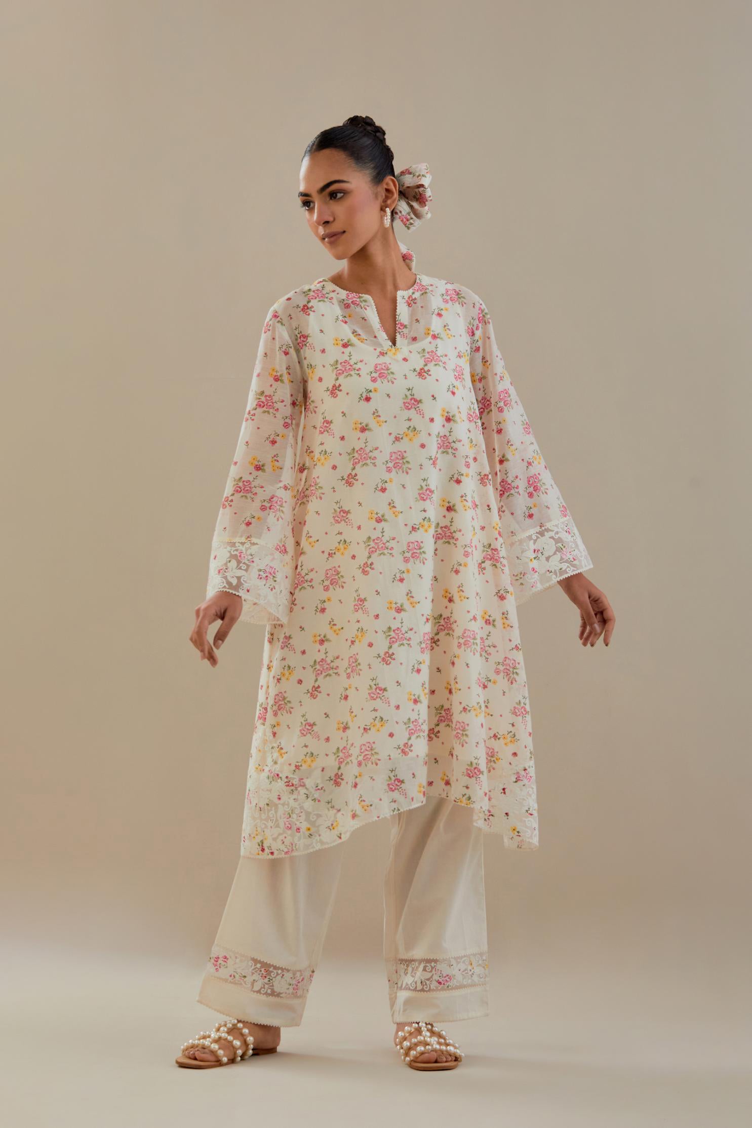 Off white cotton chanderi A-line short kurta set with small floral hand block print, highlighted with applique embroidery and ricrac lace.