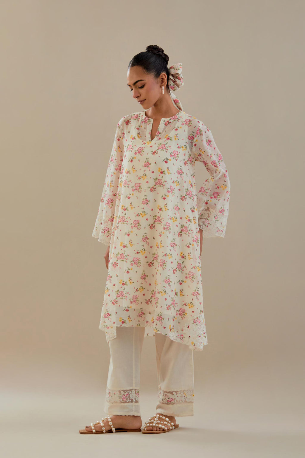 Off white cotton chanderi A-line short kurta set with small floral hand block print, highlighted with applique embroidery and ricrac lace.
