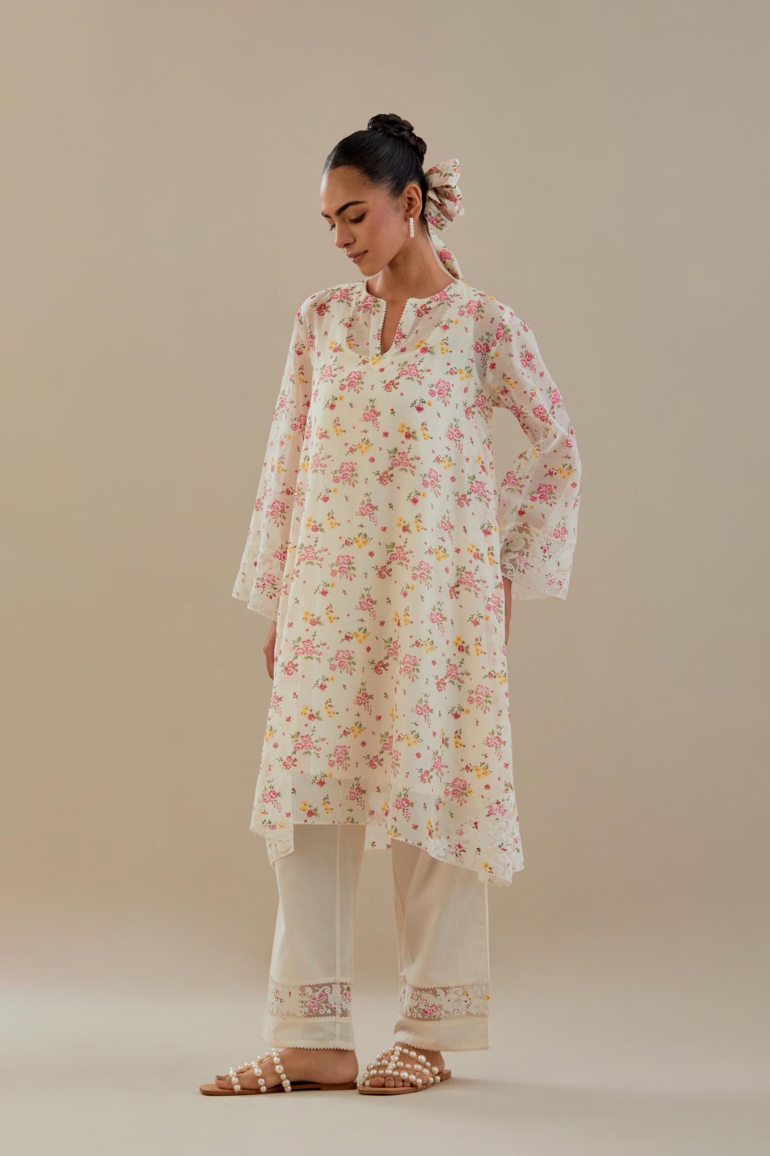 Off white cotton chanderi A-line short kurta set with small floral hand block print, highlighted with applique embroidery and ricrac lace.