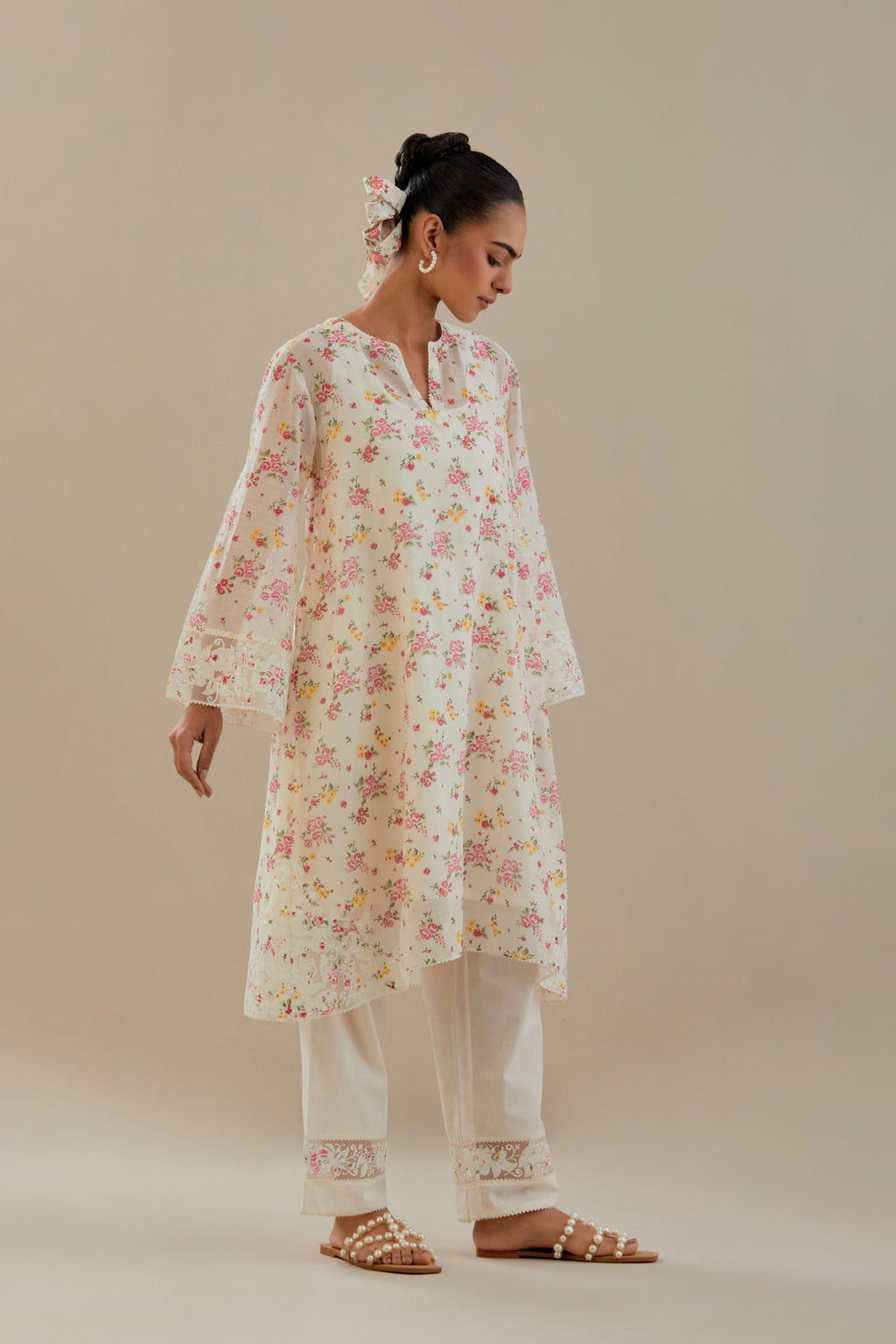 Off white cotton chanderi A-line short kurta set with small floral hand block print, highlighted with applique embroidery and ricrac lace.