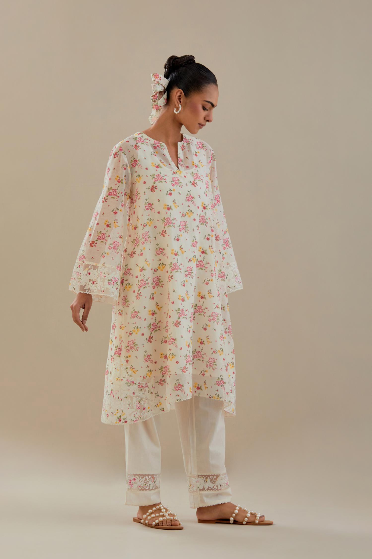 Off white cotton chanderi A-line short kurta set with small floral hand block print, highlighted with applique embroidery and ricrac lace.