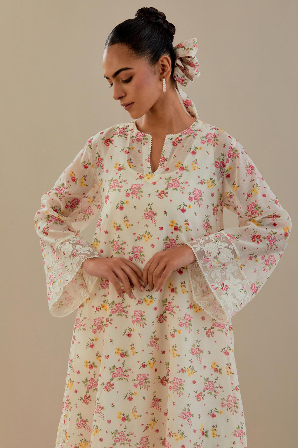 Off white cotton chanderi A-line short kurta set with small floral hand block print, highlighted with applique embroidery and ricrac lace.