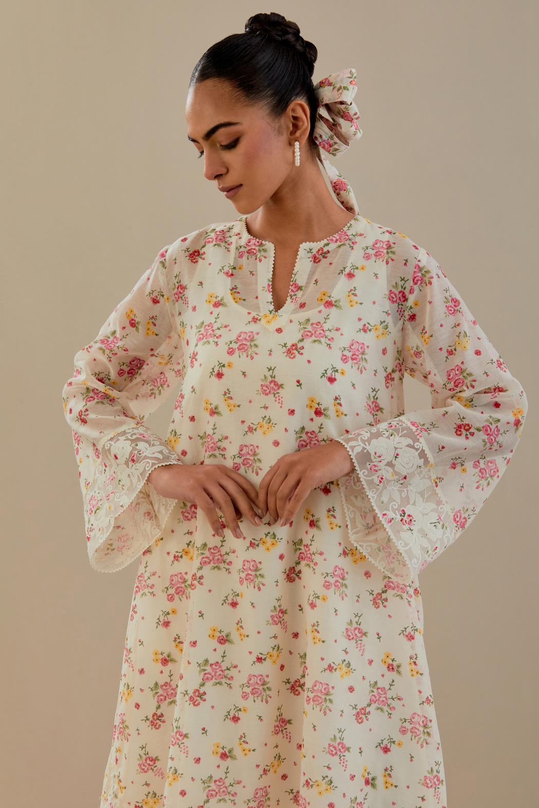 Off white cotton chanderi A-line short kurta set with small floral hand block print, highlighted with applique embroidery and ricrac lace.