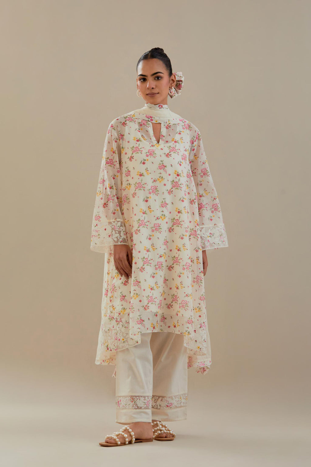 Off white cotton chanderi A-line short kurta set with small floral hand block print, highlighted with applique embroidery and ricrac lace.