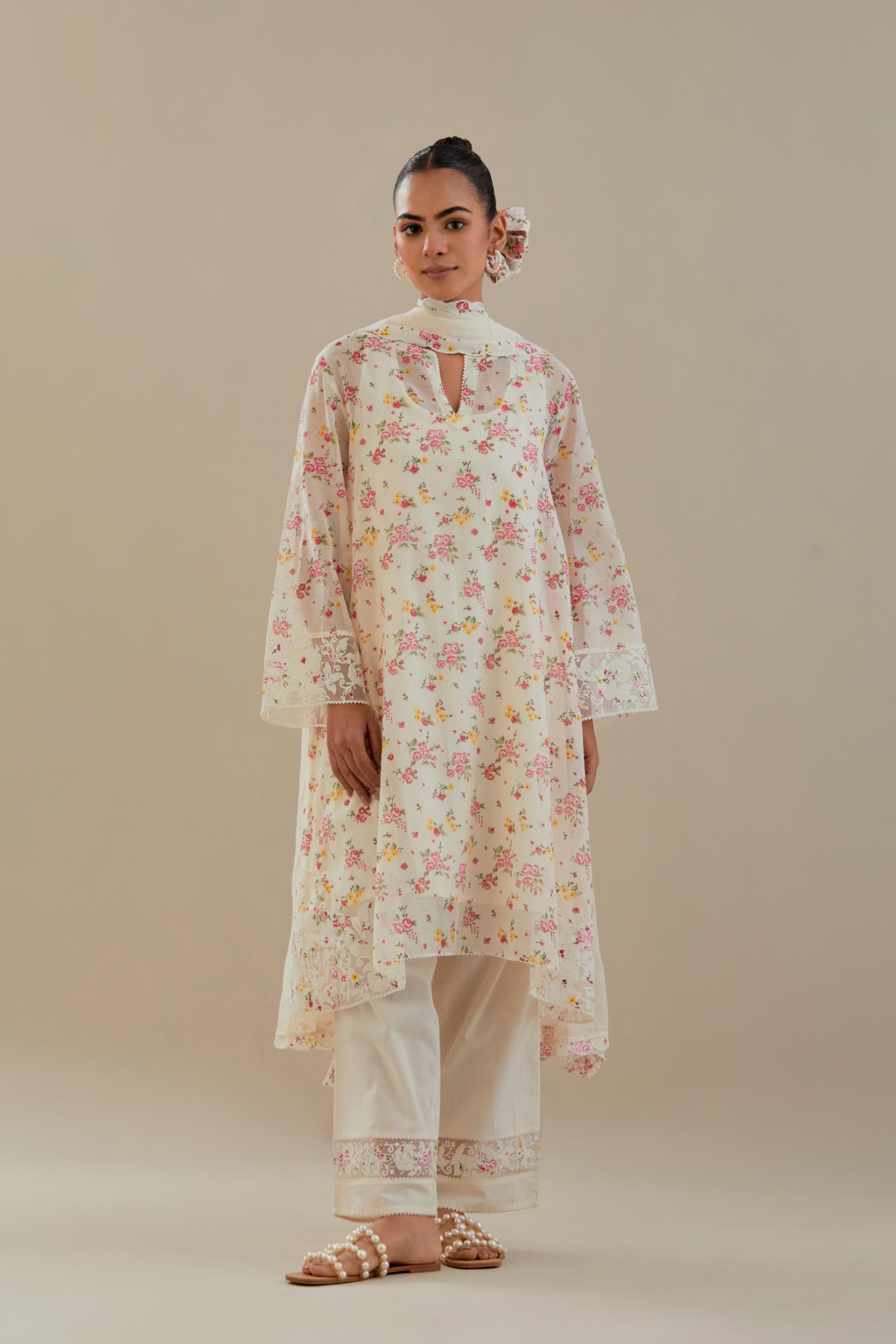 Off white cotton chanderi A-line short kurta set with small floral hand block print, highlighted with applique embroidery and ricrac lace.