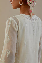 Off white cotton chanderi straight kurta set with button placket neckline, highlighted with all-over off white dori embroidery, paired with off white cotton strai. 
