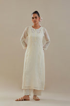 Off white cotton chanderi straight kurta set with button placket neckline, highlighted with all-over off white dori embroidery, paired with off white cotton strai. 
