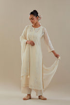 Off white cotton chanderi straight kurta set with button placket neckline, highlighted with all-over off white dori embroidery, paired with off white cotton strai. 