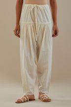 Off white cotton salwar with off white dori embroidery, highlighted with sequins work.