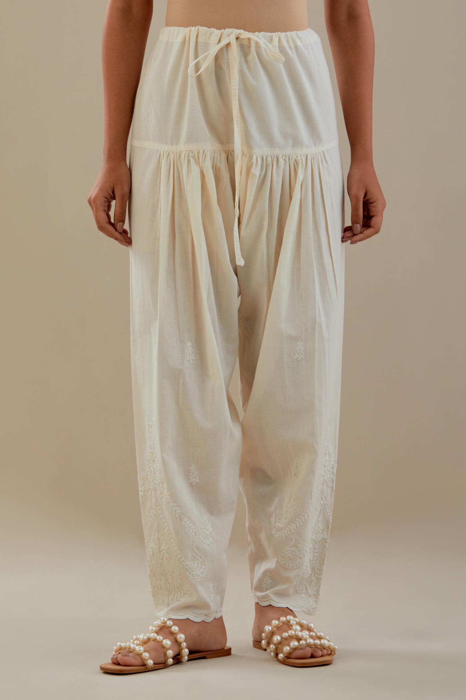 Off white cotton salwar with off white dori embroidery, highlighted with sequins work.