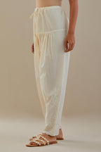 Off white cotton salwar with off white dori embroidery, highlighted with sequins work.