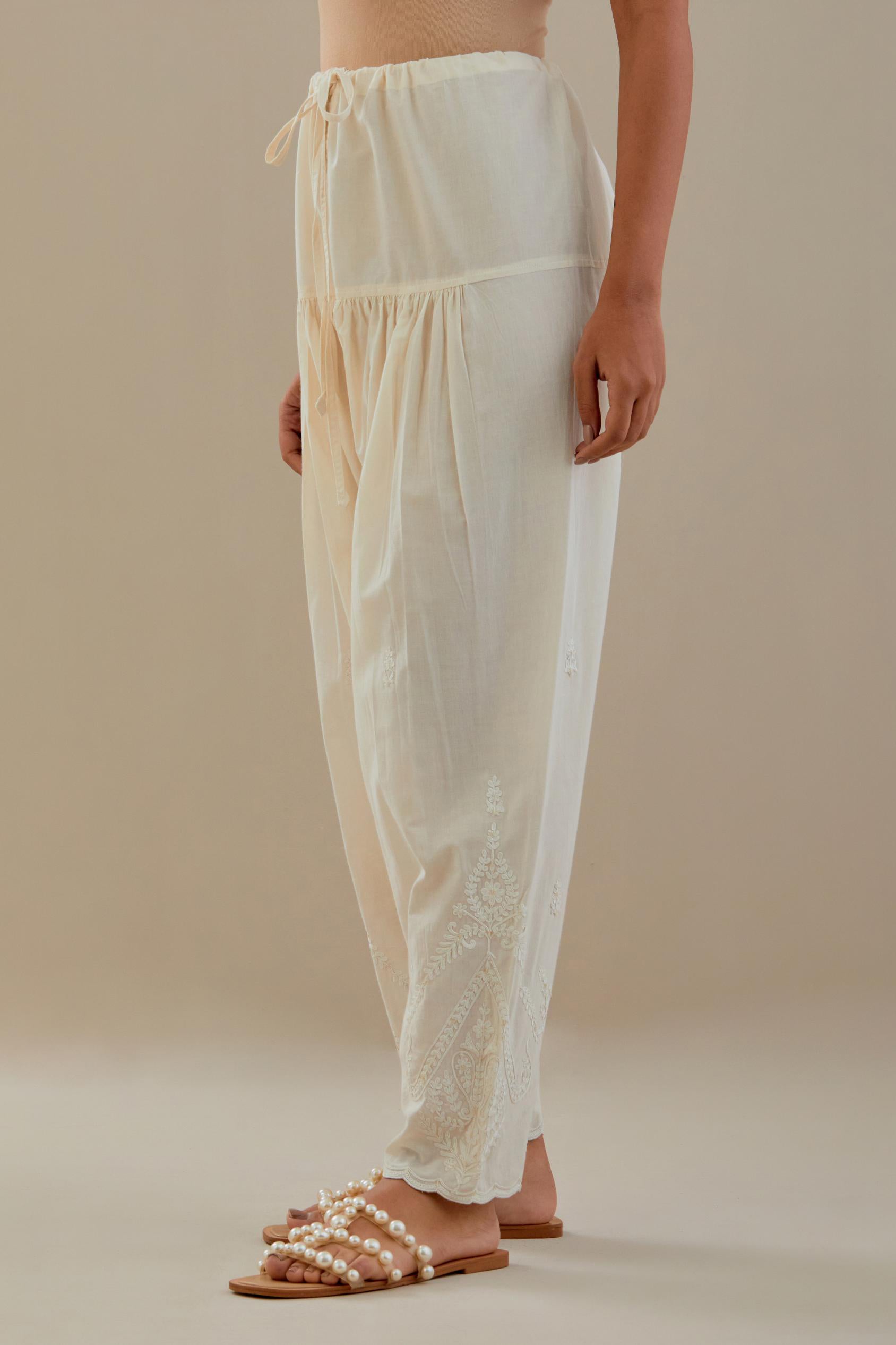 Off white cotton salwar with off white dori embroidery, highlighted with sequins work.