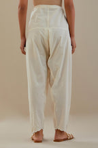 Off white cotton salwar with off white dori embroidery, highlighted with sequins work.
