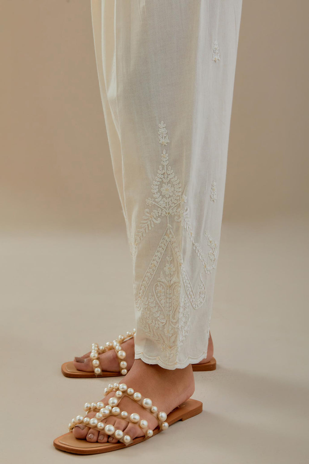 Off white cotton salwar with off white dori embroidery, highlighted with sequins work.
