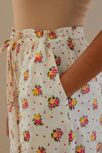 Off white cotton straight pants with all-over small multi colored hand block print, detailed with applique work at bottom.