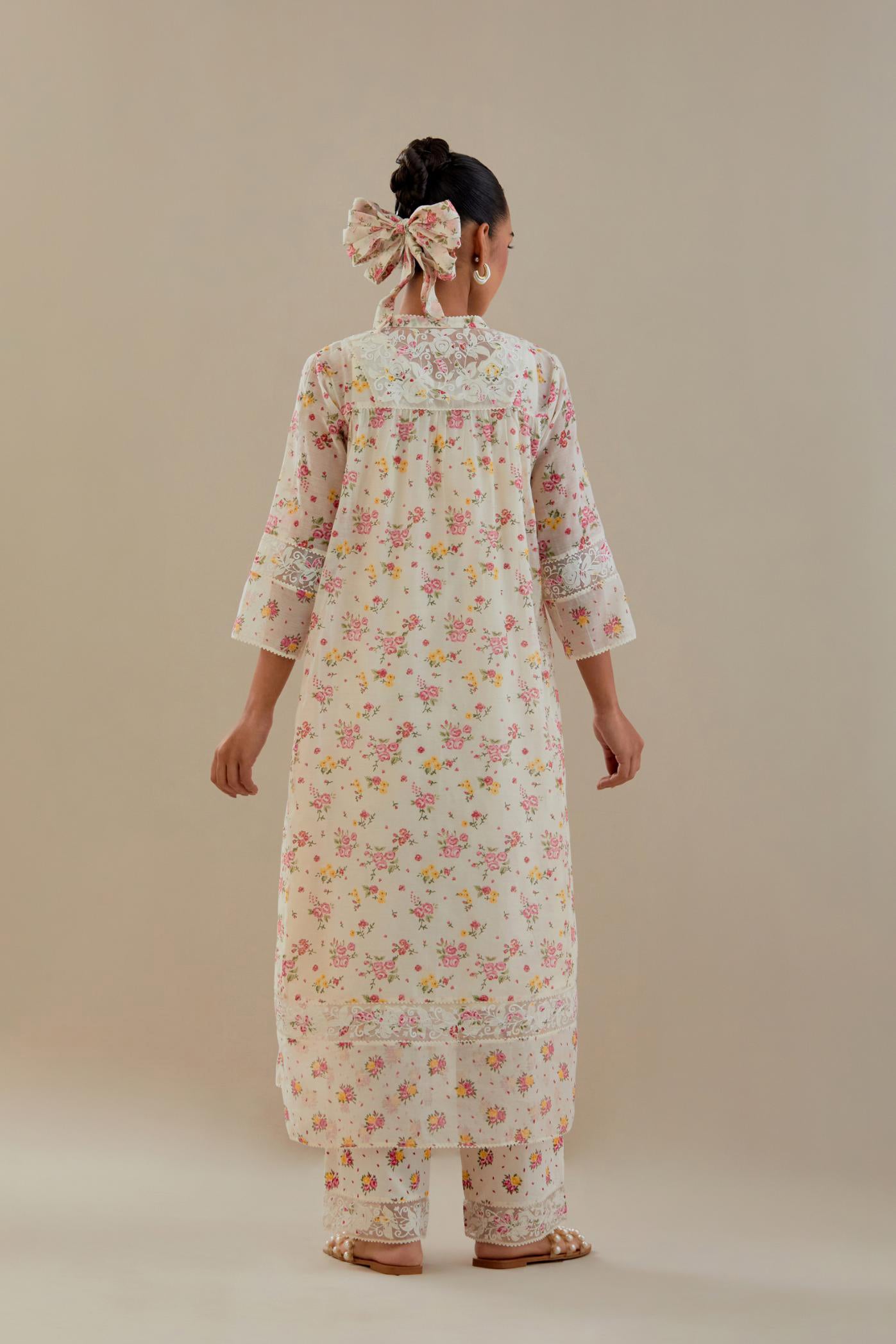 Off white cotton chanderi Kurta set dress with all-over small multi colored hand block print, highlighted with applique embroidery and ricrac lace.