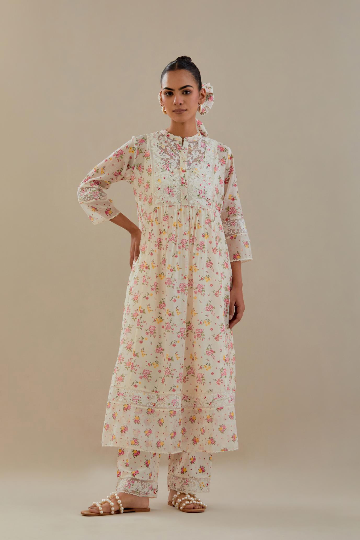 Off white cotton chanderi Kurta set dress with all-over small multi colored hand block print, highlighted with applique embroidery and ricrac lace.