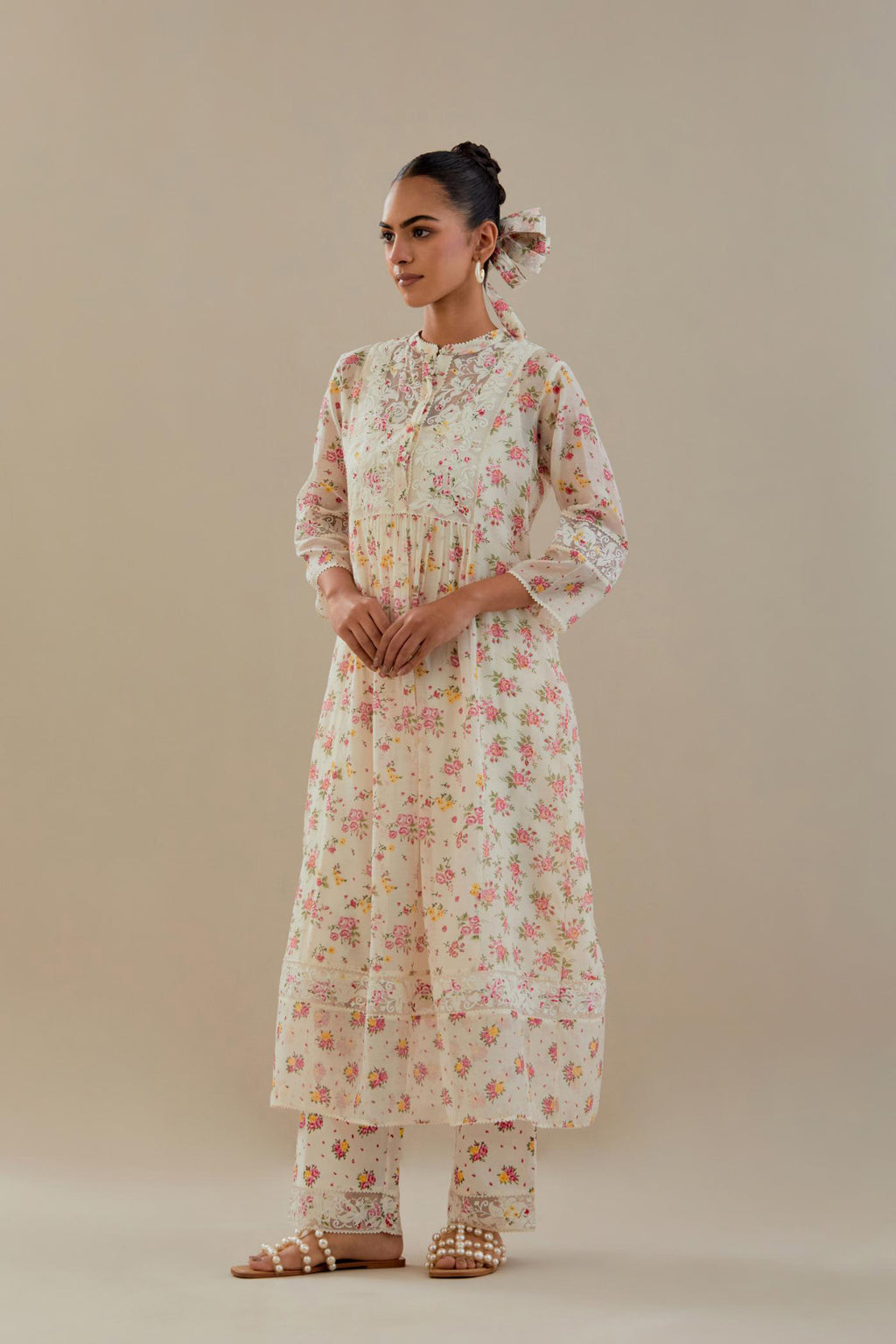 Off white cotton chanderi Kurta set dress with all-over small multi colored hand block print, highlighted with applique embroidery and ricrac lace.