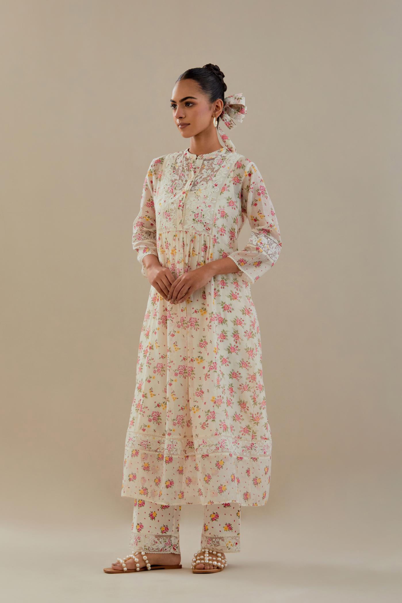 Off white cotton chanderi Kurta set dress with all-over small multi colored hand block print, highlighted with applique embroidery and ricrac lace.
