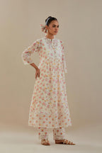 Off white cotton chanderi Kurta set dress with all-over small multi colored hand block print, highlighted with applique embroidery and ricrac lace.
