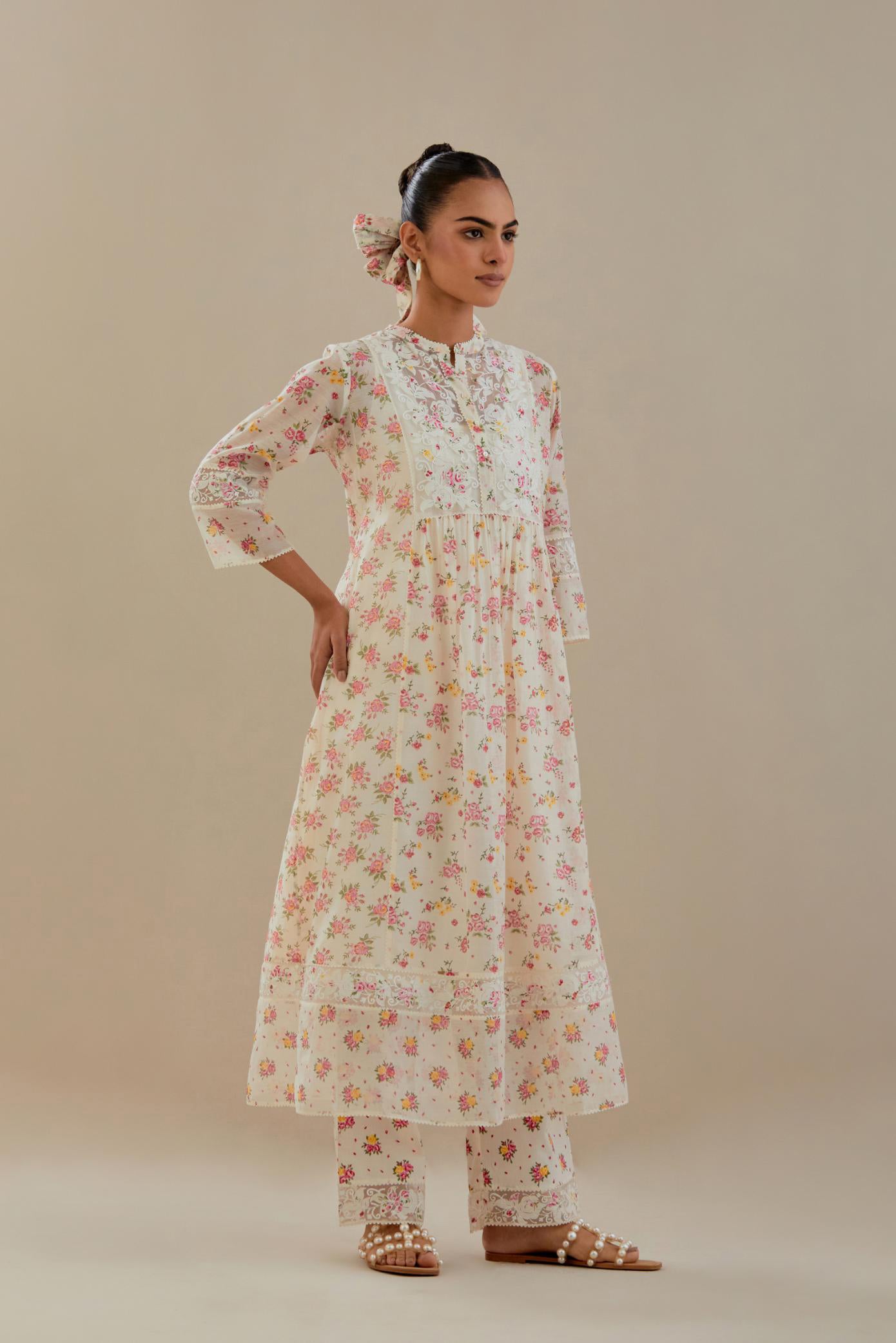 Off white cotton chanderi Kurta set dress with all-over small multi colored hand block print, highlighted with applique embroidery and ricrac lace.
