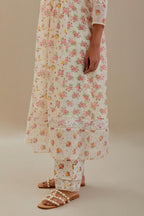Off white cotton chanderi Kurta set dress with all-over small multi colored hand block print, highlighted with applique embroidery and ricrac lace.