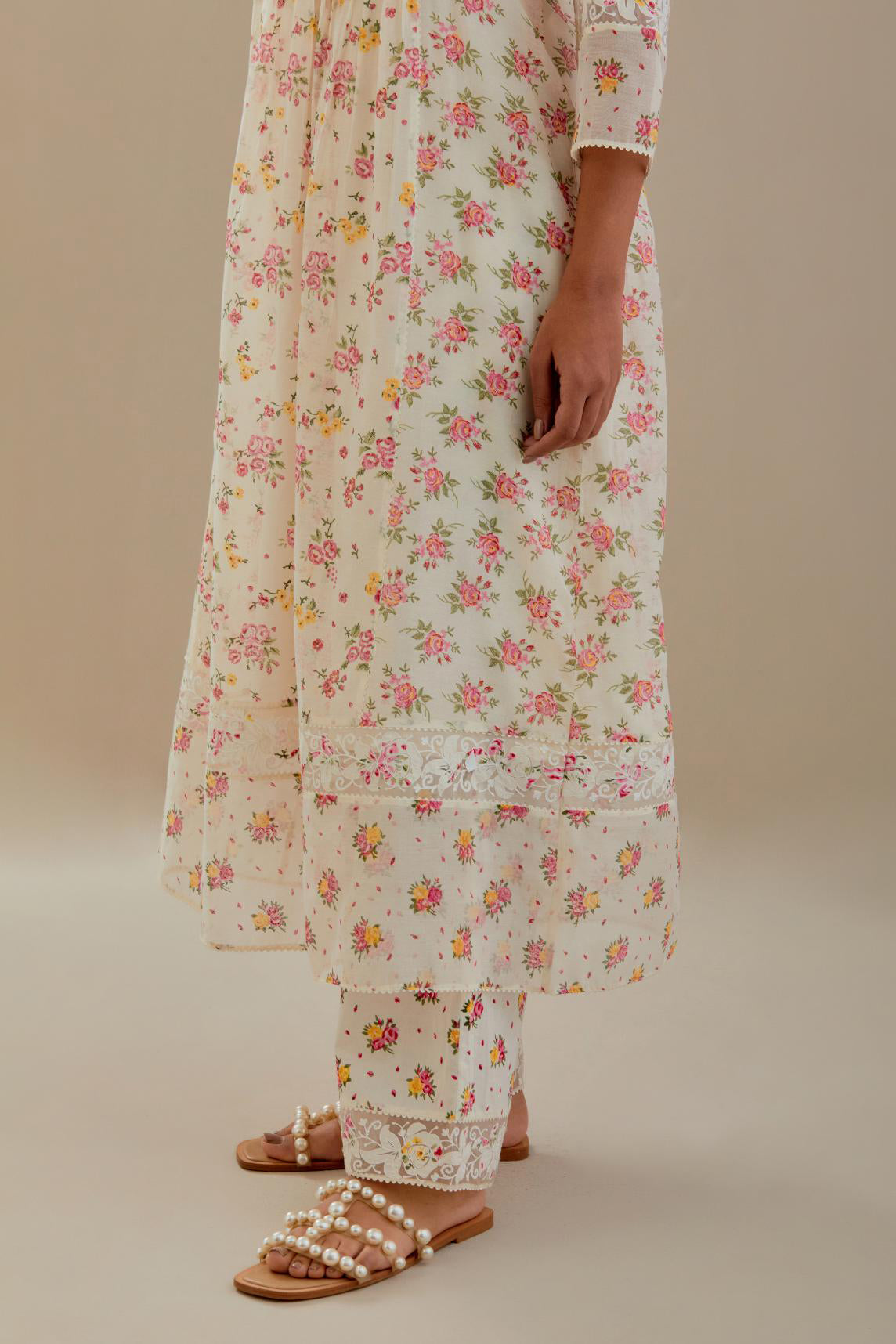 Off white cotton chanderi Kurta set dress with all-over small multi colored hand block print, highlighted with applique embroidery and ricrac lace.