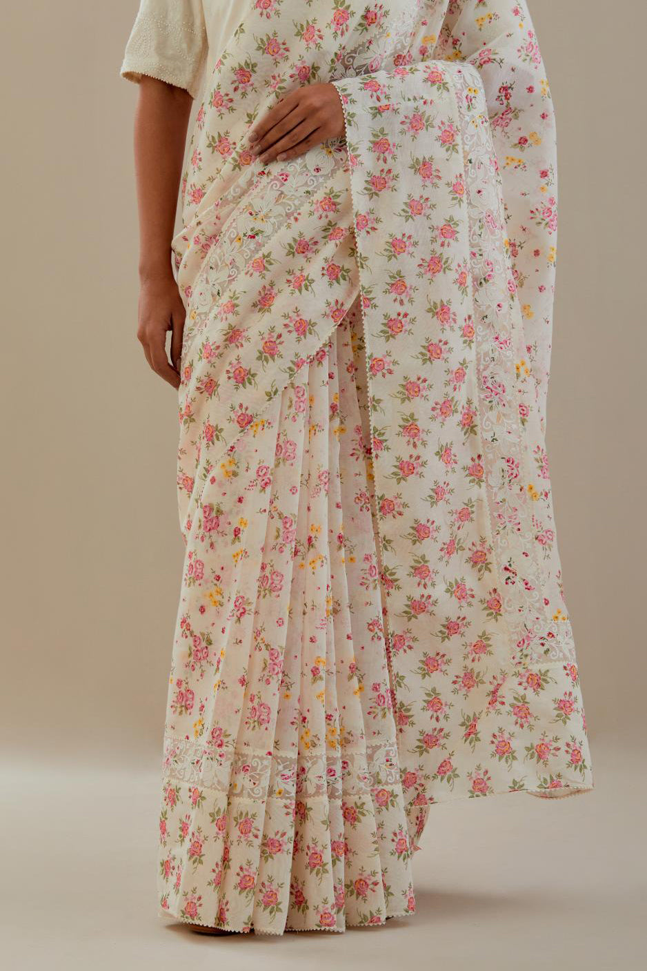 Off white cotton chanderi saree, highlighted with all-over small multi colored floral hand block print, highlighted with ricrac lace & applique, paired with off-white cotton blouse with thread embroidery & bead work.