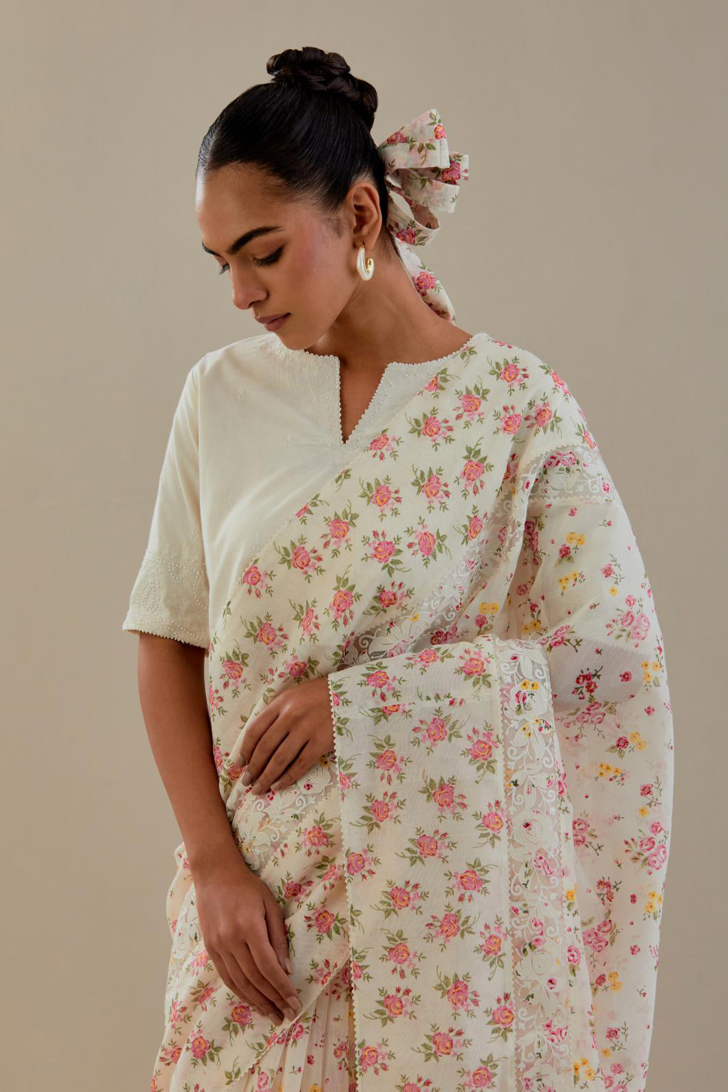 Off white cotton chanderi saree, highlighted with all-over small multi colored floral hand block print, highlighted with ricrac lace & applique, paired with off-white cotton blouse with thread embroidery & bead work.