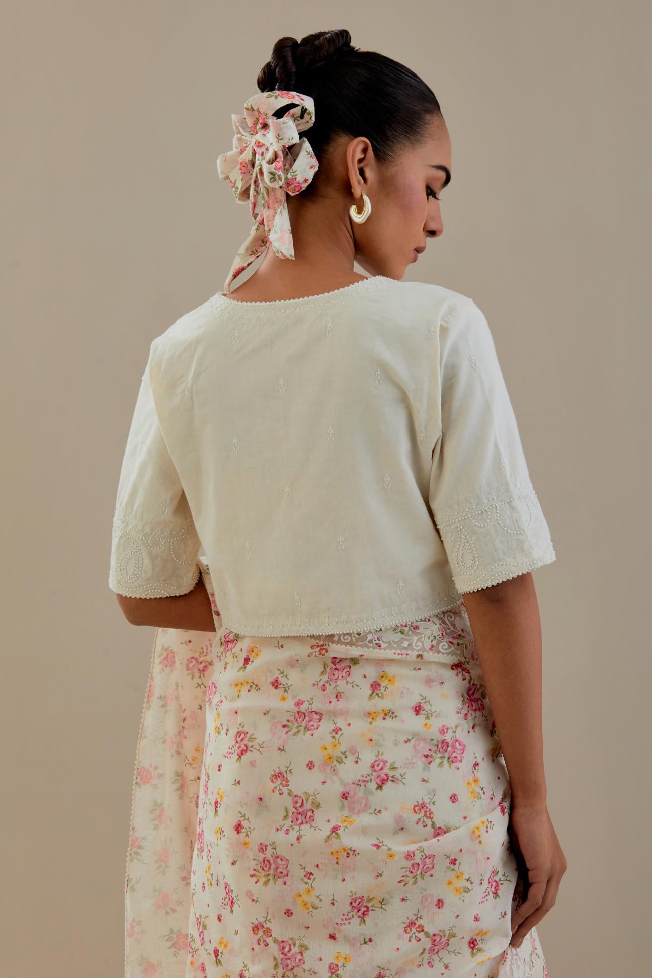 Off-white cotton blouse with thread embroidery & bead work.
