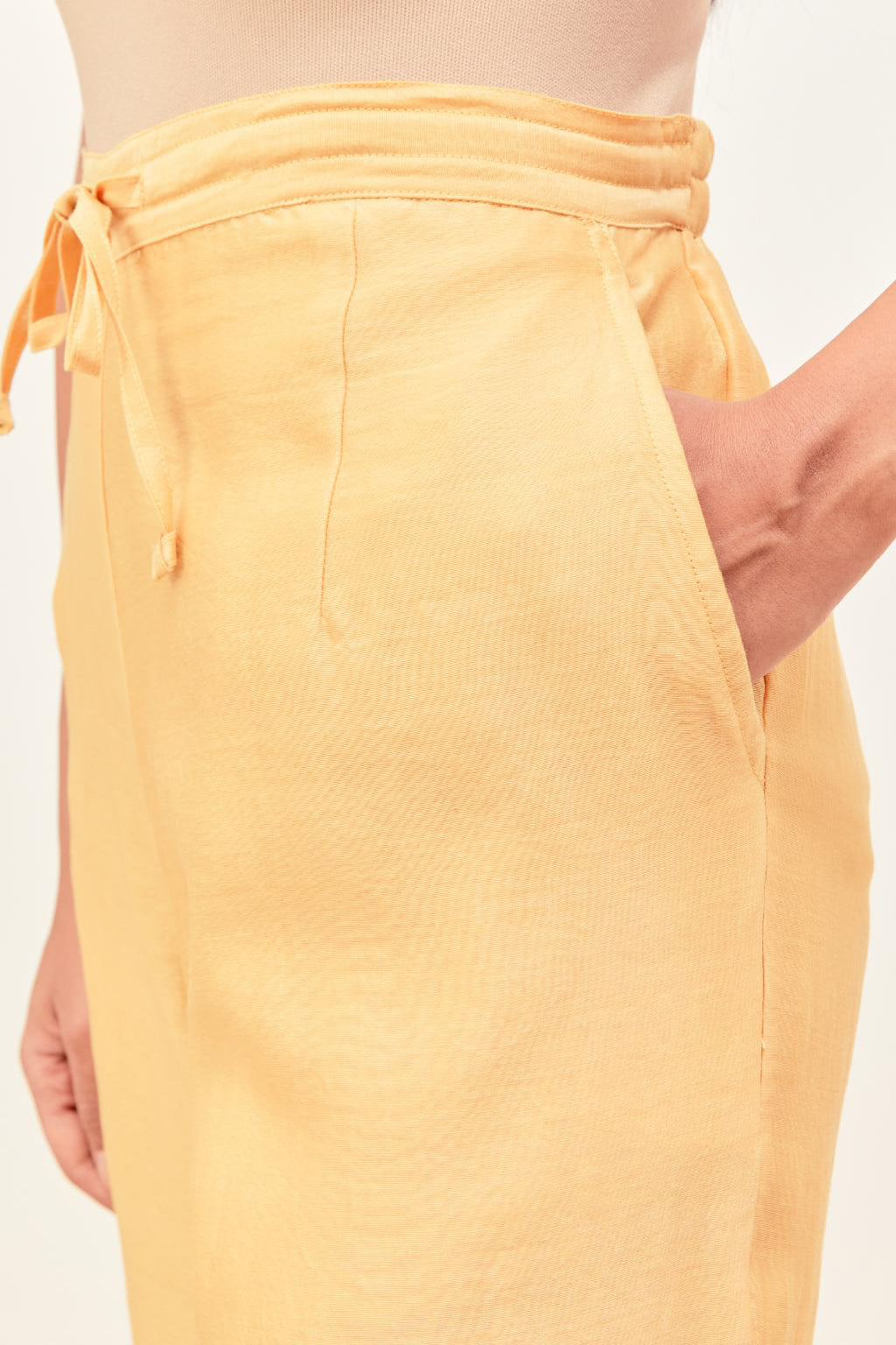 Yellow silk chanderi straight pants detailed with multi colored applique, highlighted with sequins work at bottom hem.